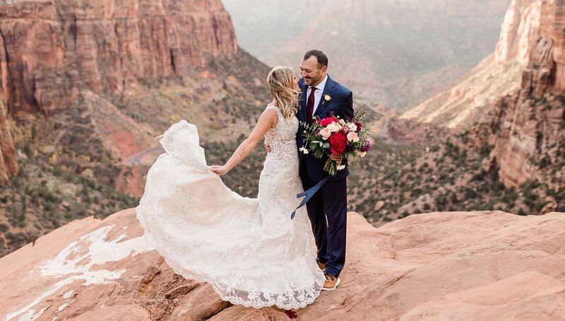 Zion elopement couple standing atop a cliff