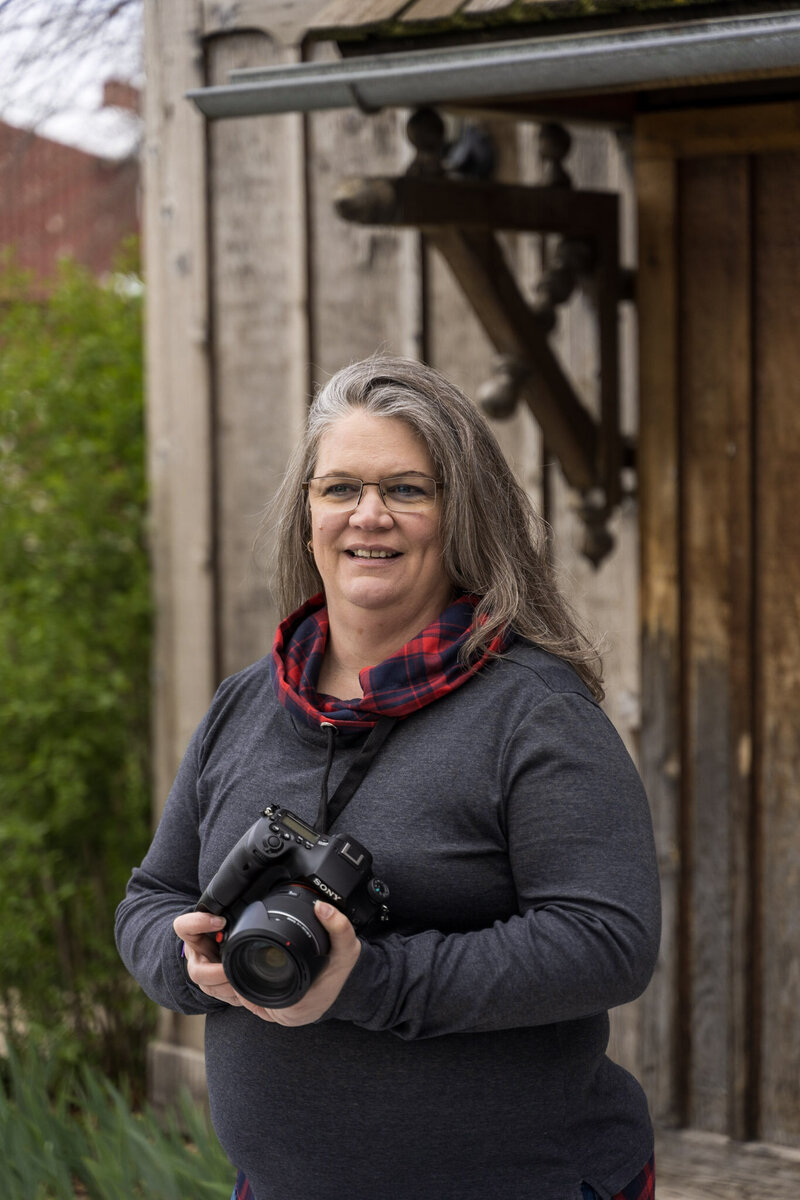 Photographer Amy Hodder holds her camera, ready to capture memories at Lakewood Heritage Center - Amy Hodder Photography