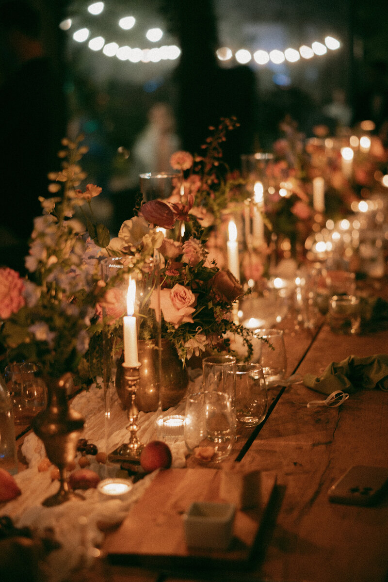 Candlelit tablescape decorated with floral arrangements