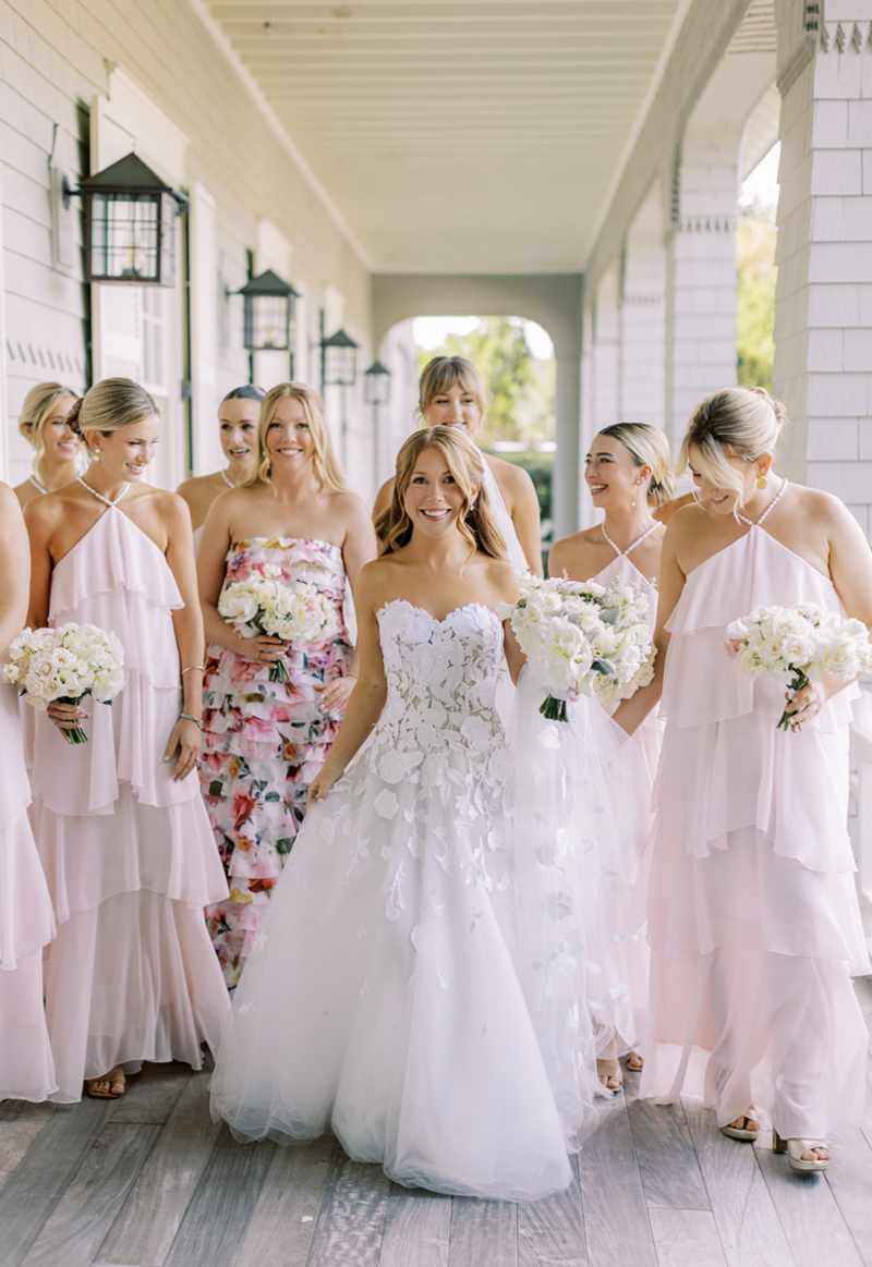 Bride and groom holding hands with bouquet