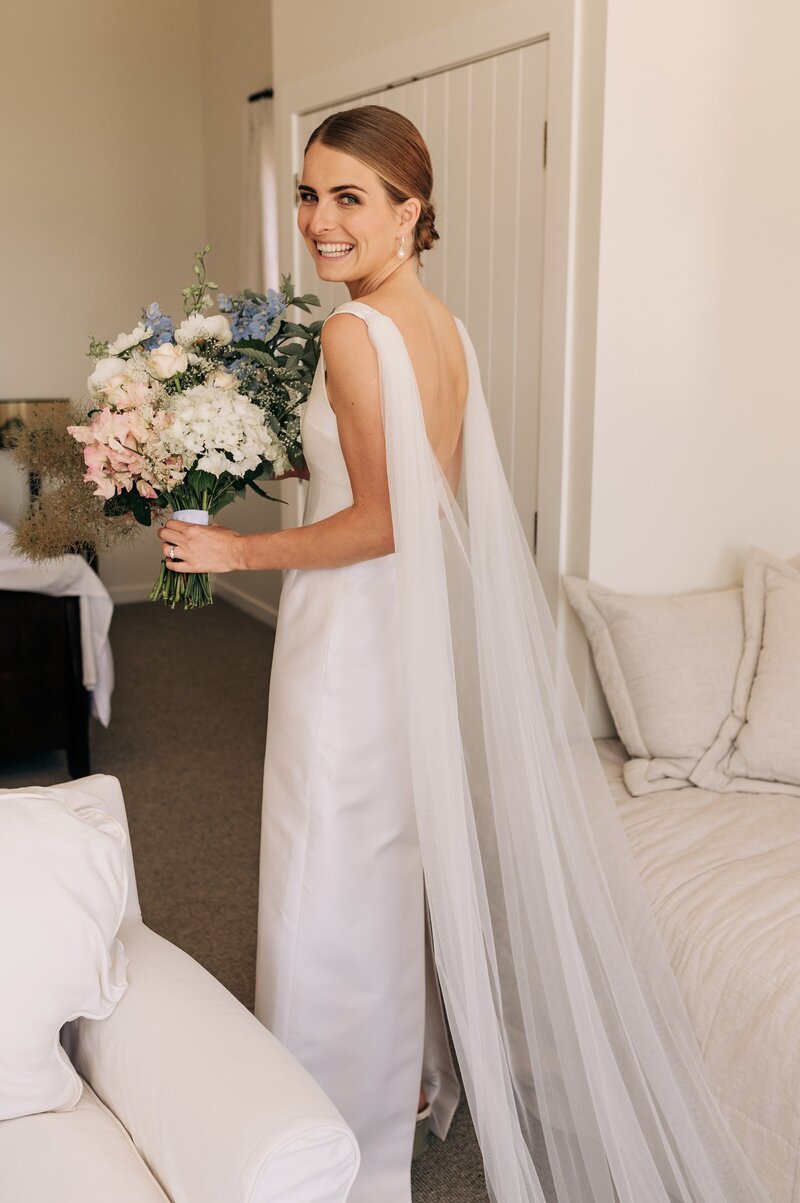 bride in emilia wickstead dress and pastel bouquet in blenheim at winter hills new zealand