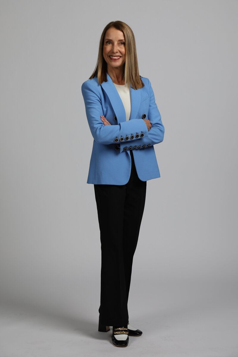 A sustainability consultant confidently posing for the camera, showcasing professionalism and expertise in their field