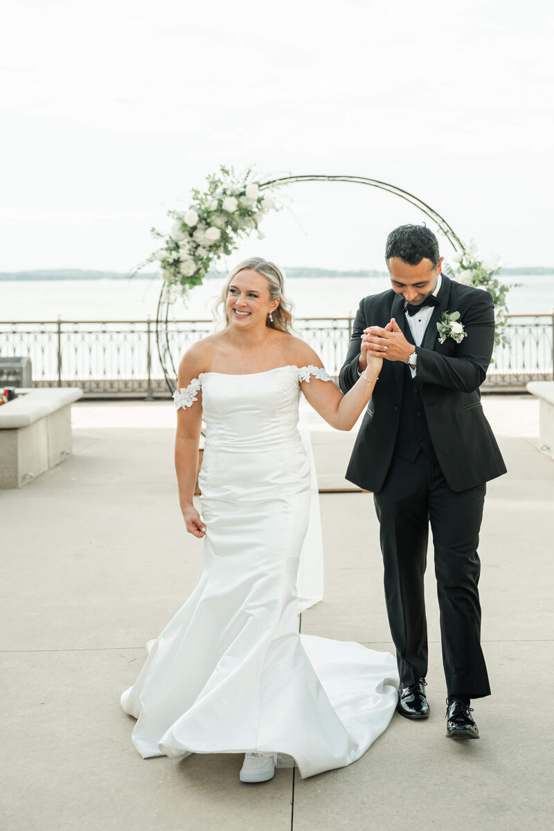 A bride and groom walking up the aisle at The Edgewater Hotel by Madison, WI wedding photographers Morgan Madeleine Photography