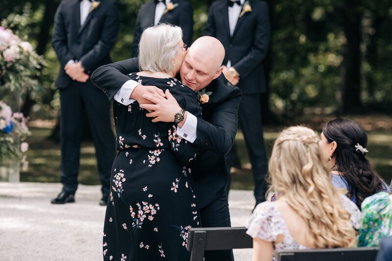 groom hugs grandma in candid moment at ceremony at bangor farm