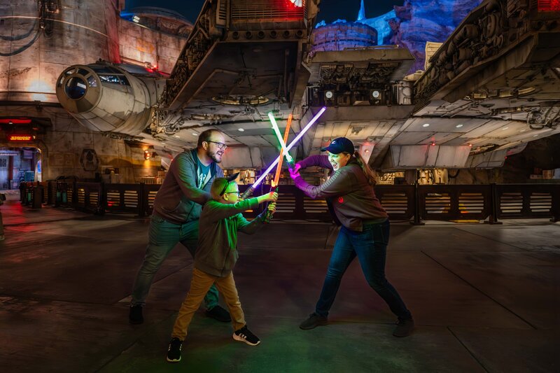 Jessie and Dallin at Disneyland using lightsabers