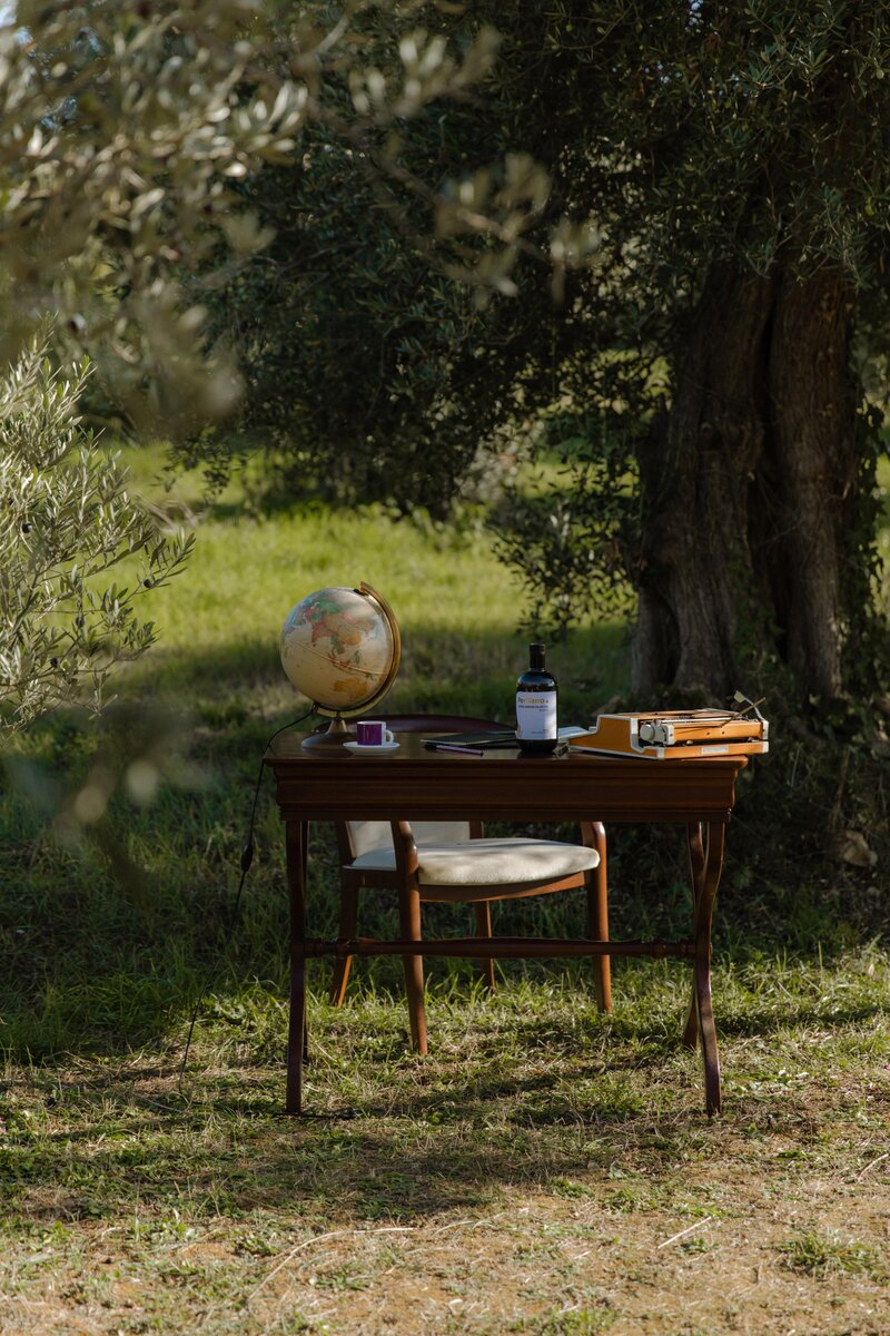 Desk outside next to olive tree