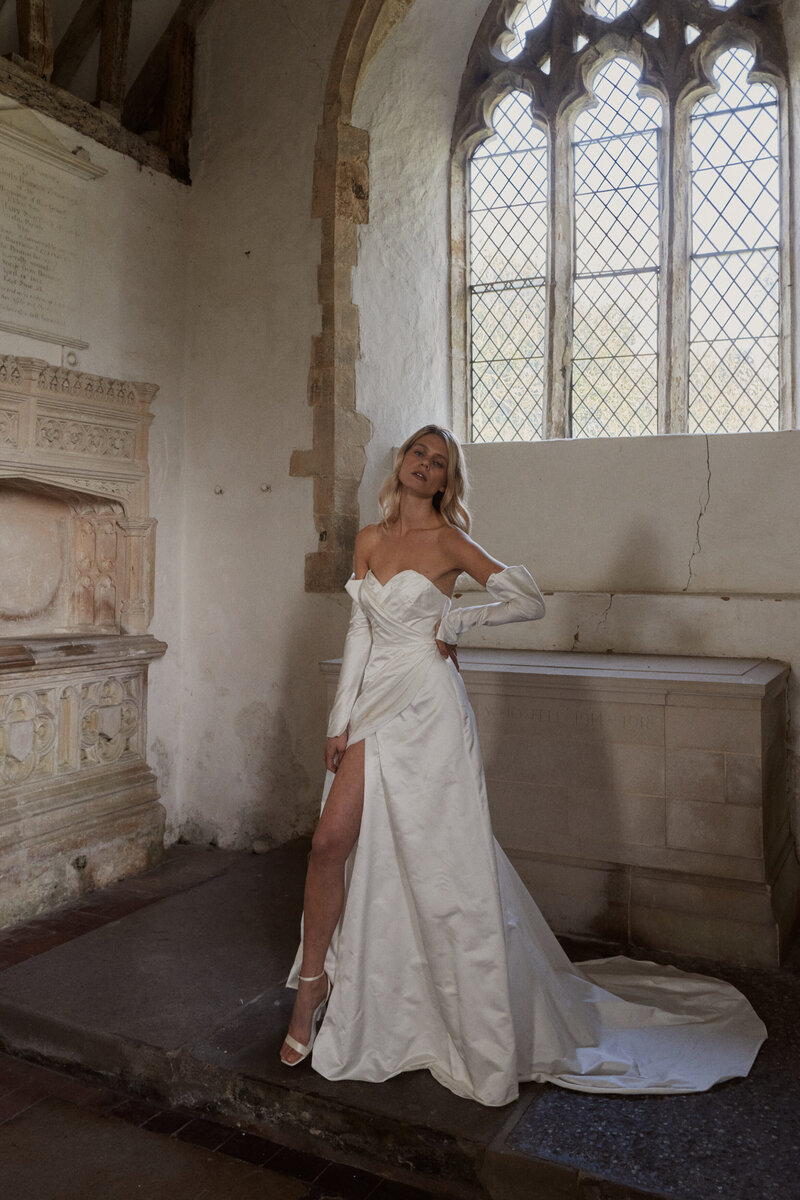 Bride wearing silk corset wedding dress in chapel