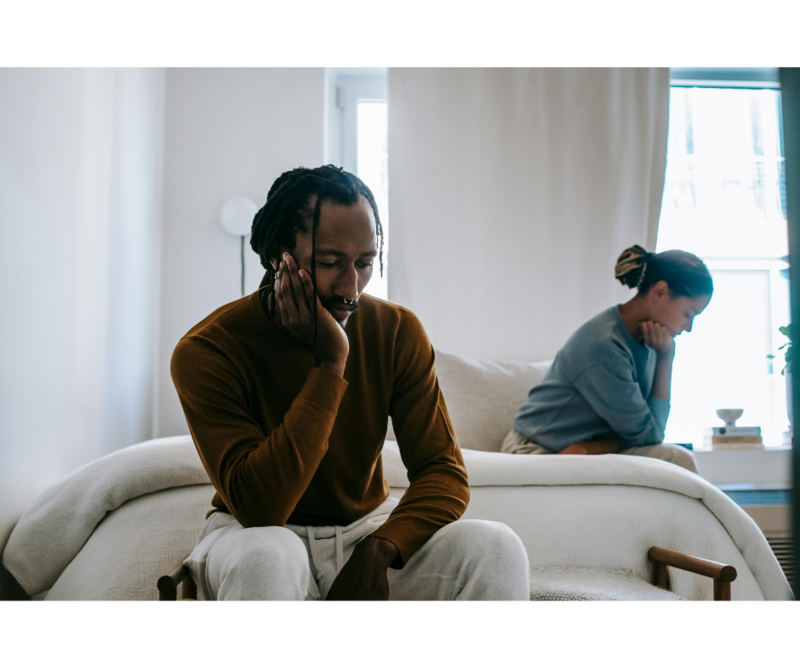 Man and Woman on a bed looking defeated