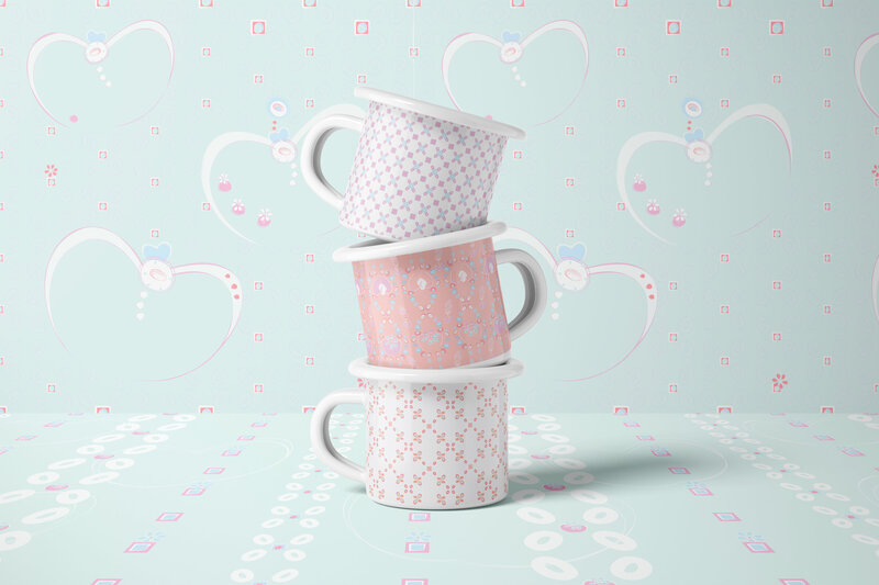 Stack of coffee mugs with pink and white patterned exteriors