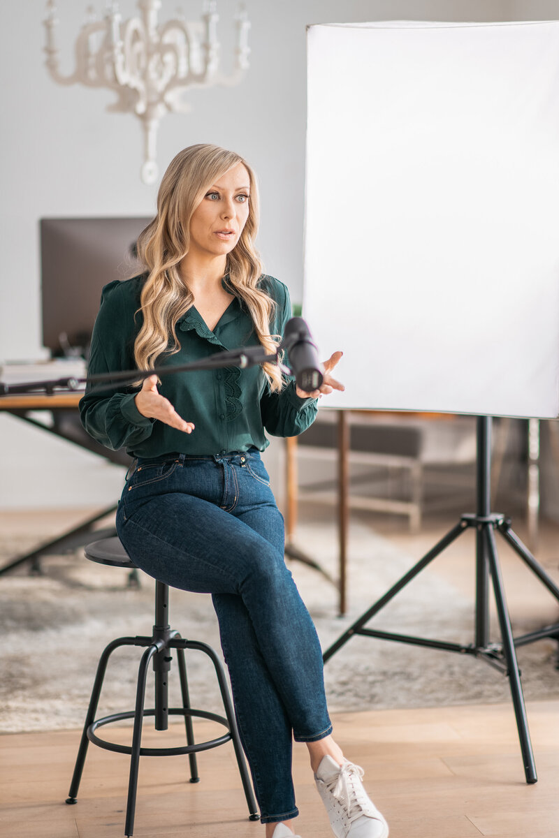 Dr. Tracy speaking into a podcast microphone