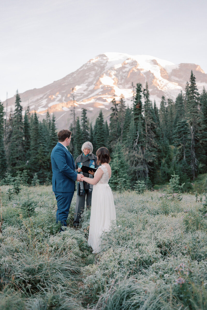 bride and groom saying vows during a mount rainier wedding ceremony
