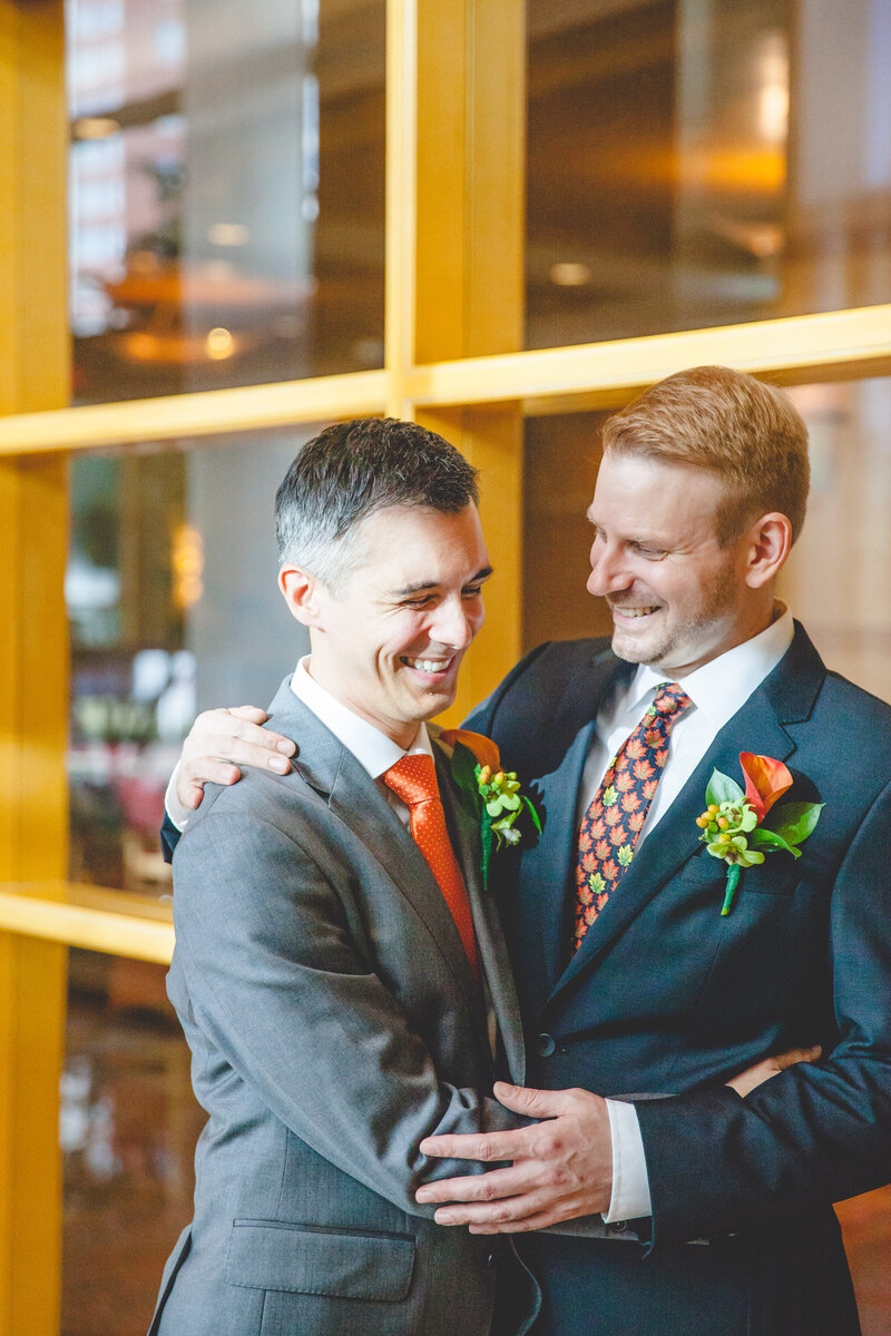 Two marriers hold one another, laughing, at Bethesda North Marriott.