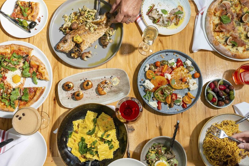 pasta dishes and wine on table