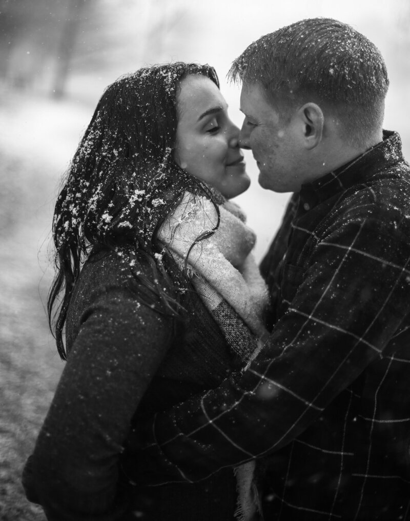 Engaged couple about to kiss at Frontier Park