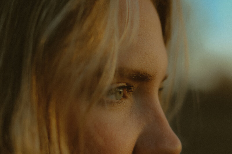 A close up of a woman's side profile, but only her eyes.