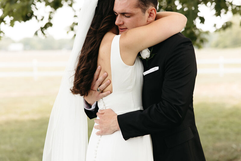 bride and groom hugging