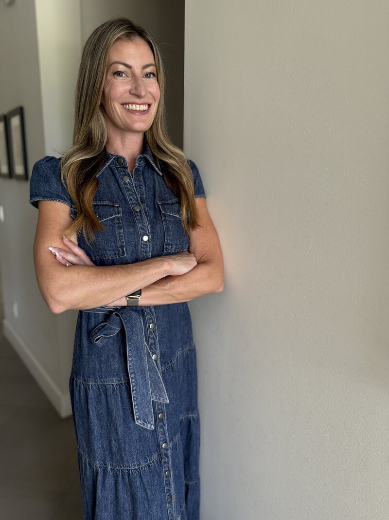 Jill smiling in a blue jean shirt