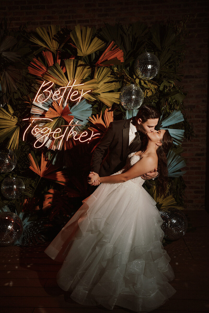 newlyweds dip and kiss during destination wedding reception Colombia
