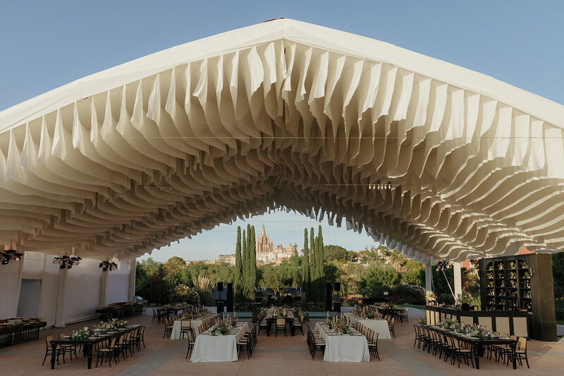Stunning floral centerpiece and place settings at outdoor wedding reception