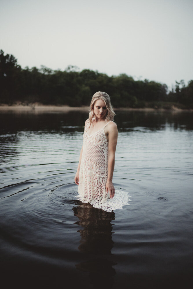 Serene image of Caroline in water, embodying grounding, intuition, and emotional balance.