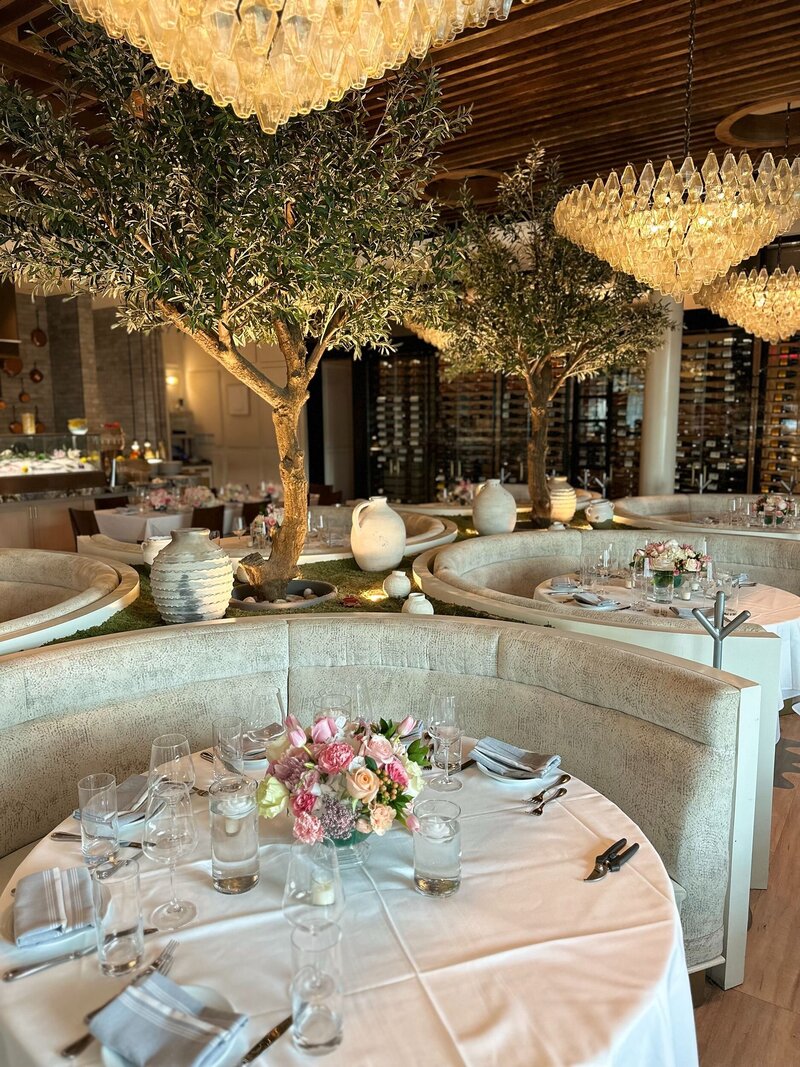 Wedding reception with trees and pink florals