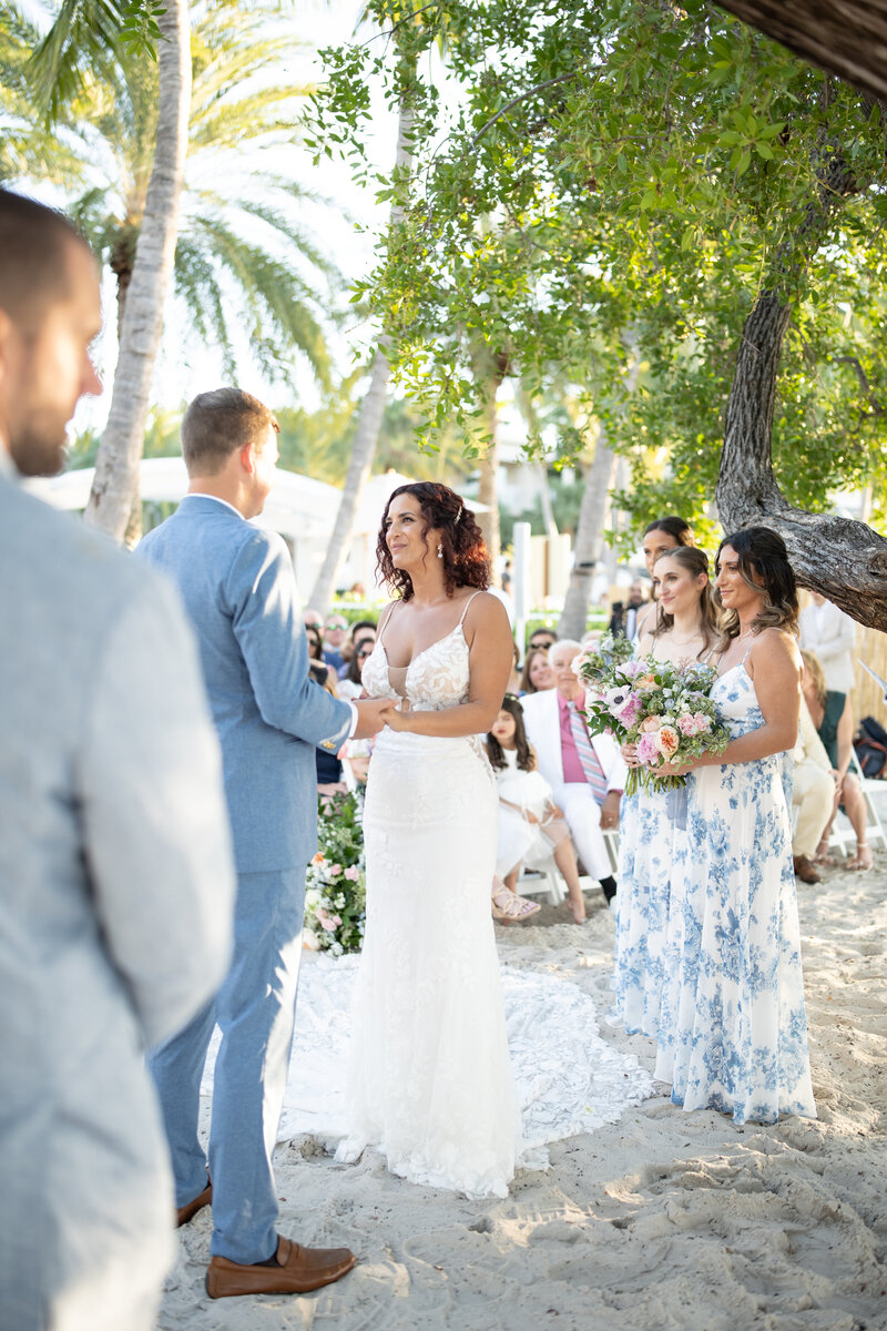 Bride and groom walking holding hands in Naples Florida