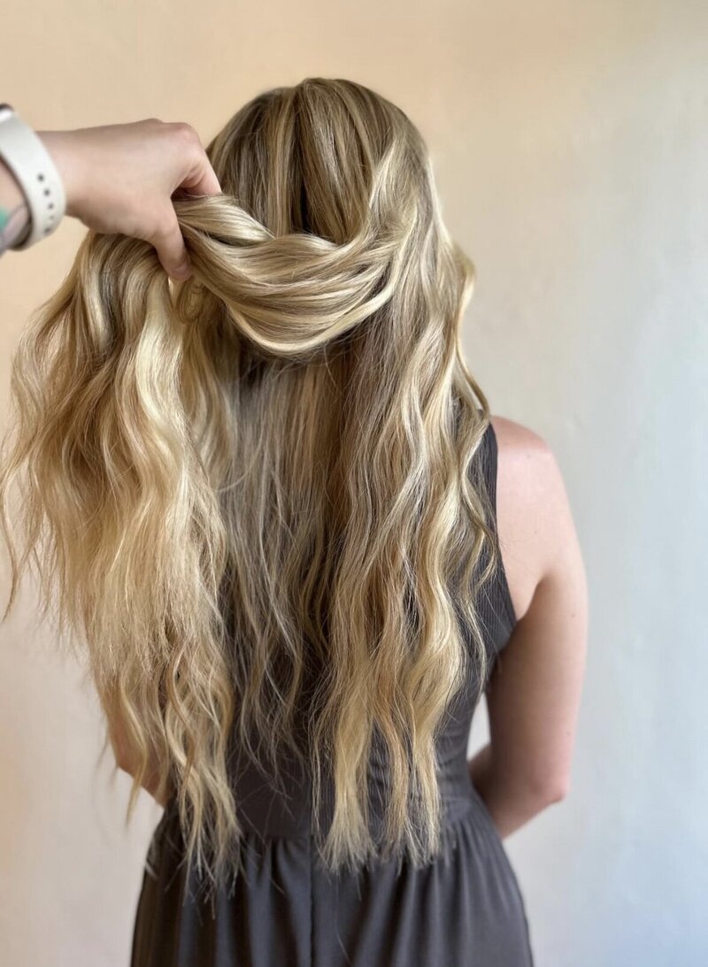 Professional stylist installing extensions at top-rated salon near Appleton WI