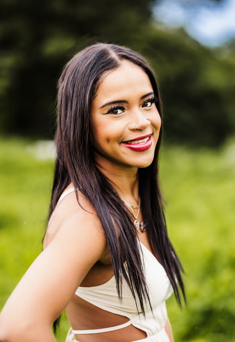 Girl standing in a Boston field for her senior pictures