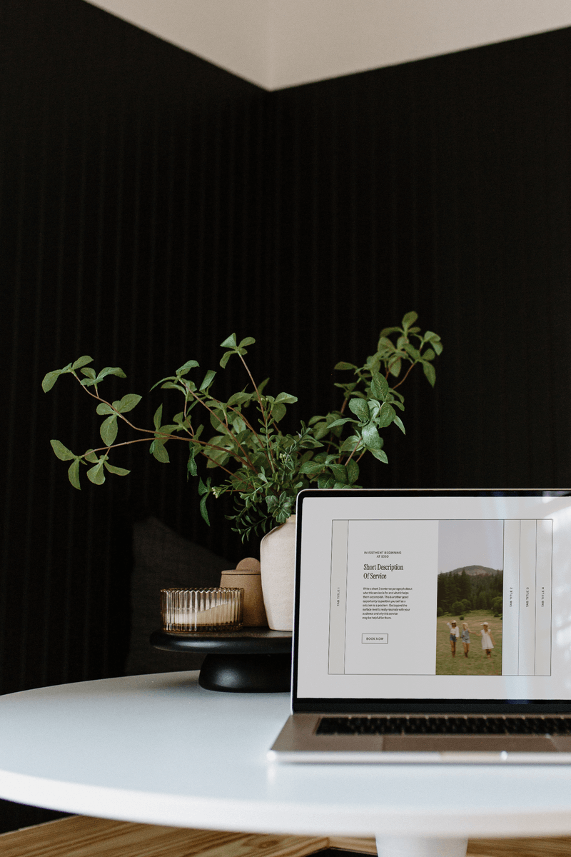 Laptop on table with plant showing branding and web design​ Flourish Foundry Designs