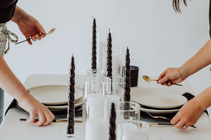 wedding coordinators setting a table with silverware