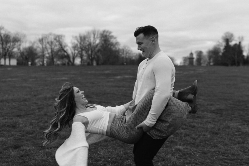 photographer taking photo of bride and groom field