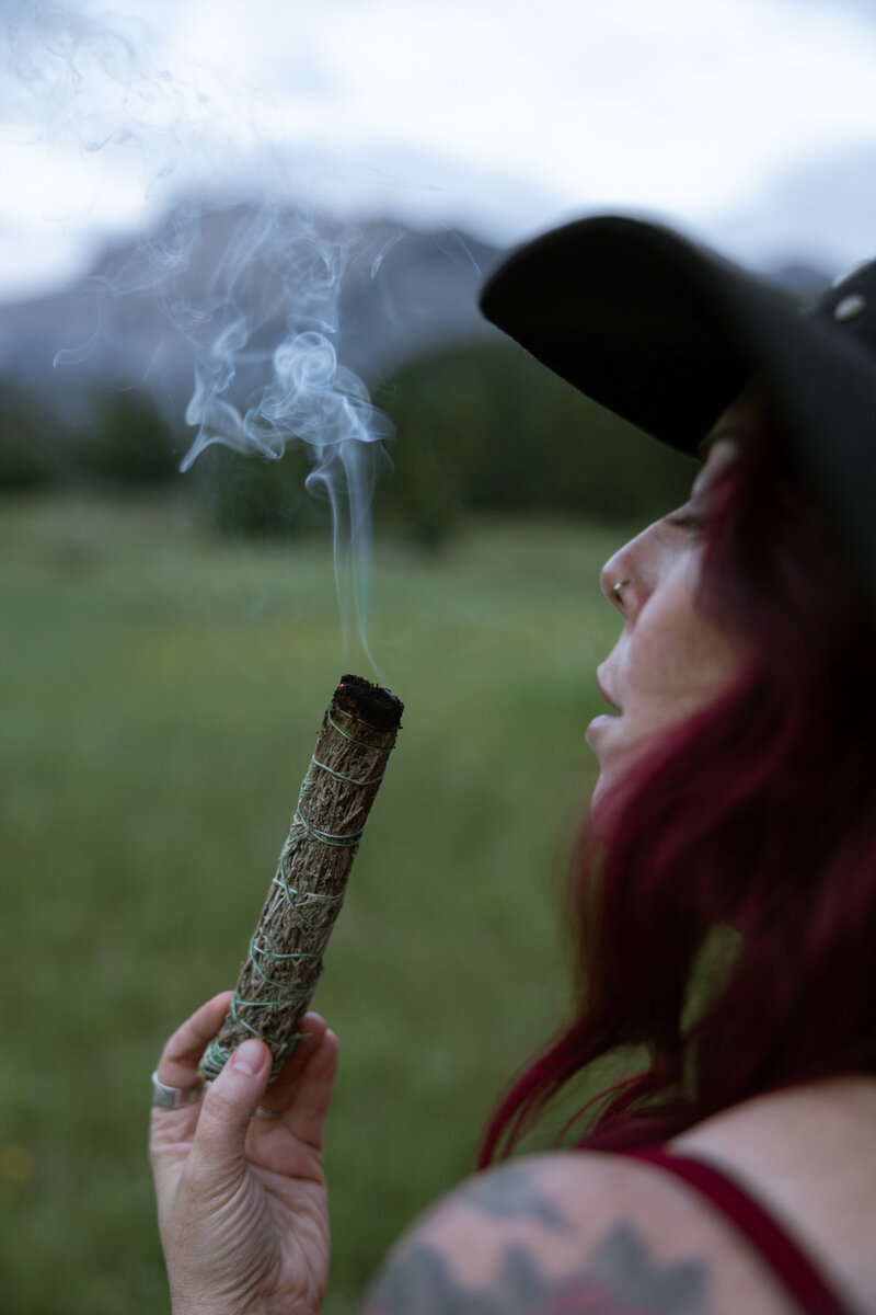 Ellen from The Guiding Raven Wellness preparing for energy clearing in the beautiful outdoors of Banff, Alberta