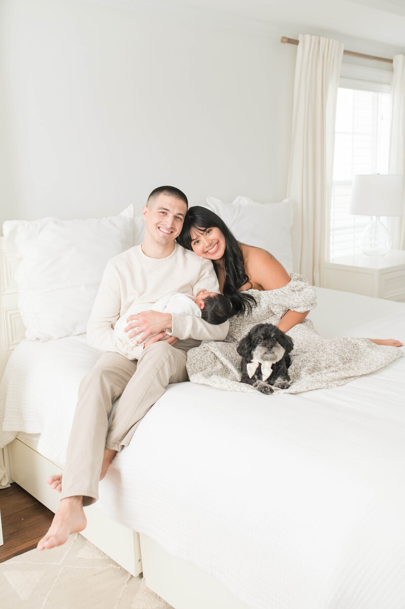 Couple with newborn baby and dog
