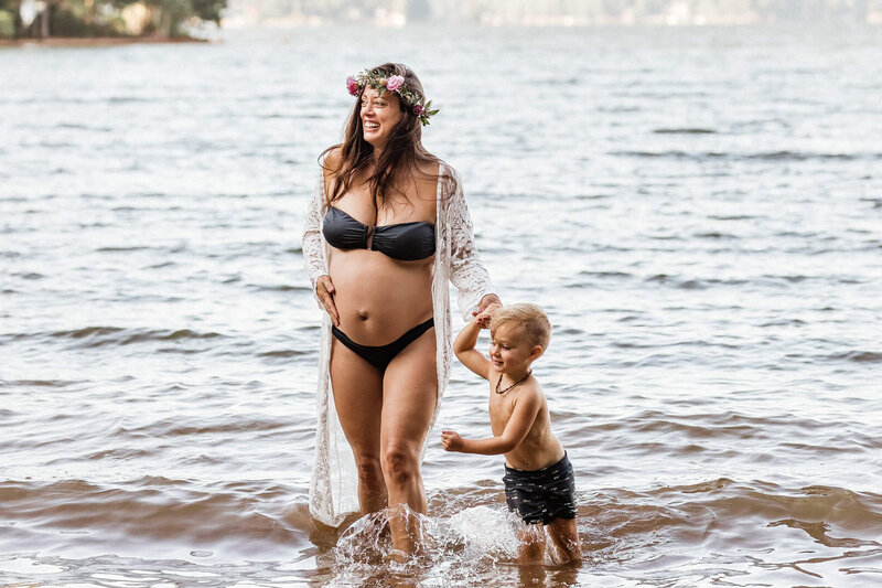 Pregnant momma standing in the lake with first child, taken by Asheville wedding photographers.
