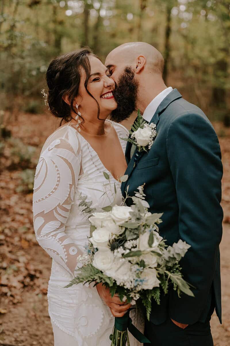 Elopement couple kissing in the woods