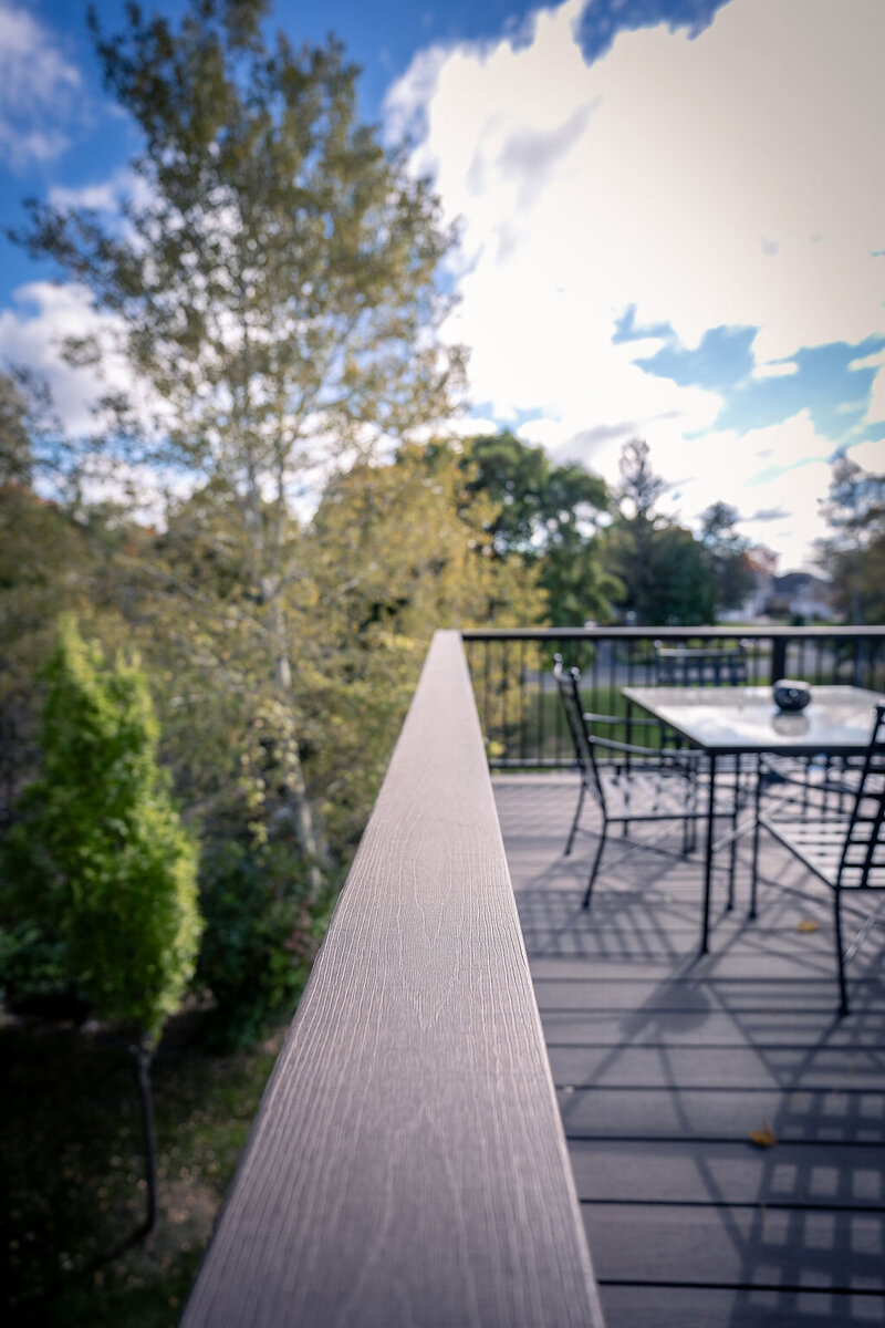 Detail view of a deck drink rail using TimberTech Advanced PVC in American Walnut. 