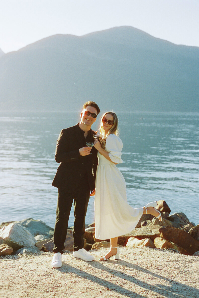 A couple drinks champagne on their wedding day on the wild coast of Vancouver Island