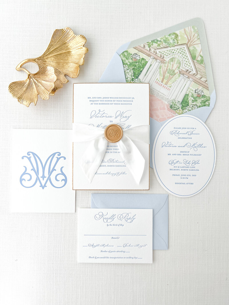 wedding stationery personalized with a monogram and venue illustration
