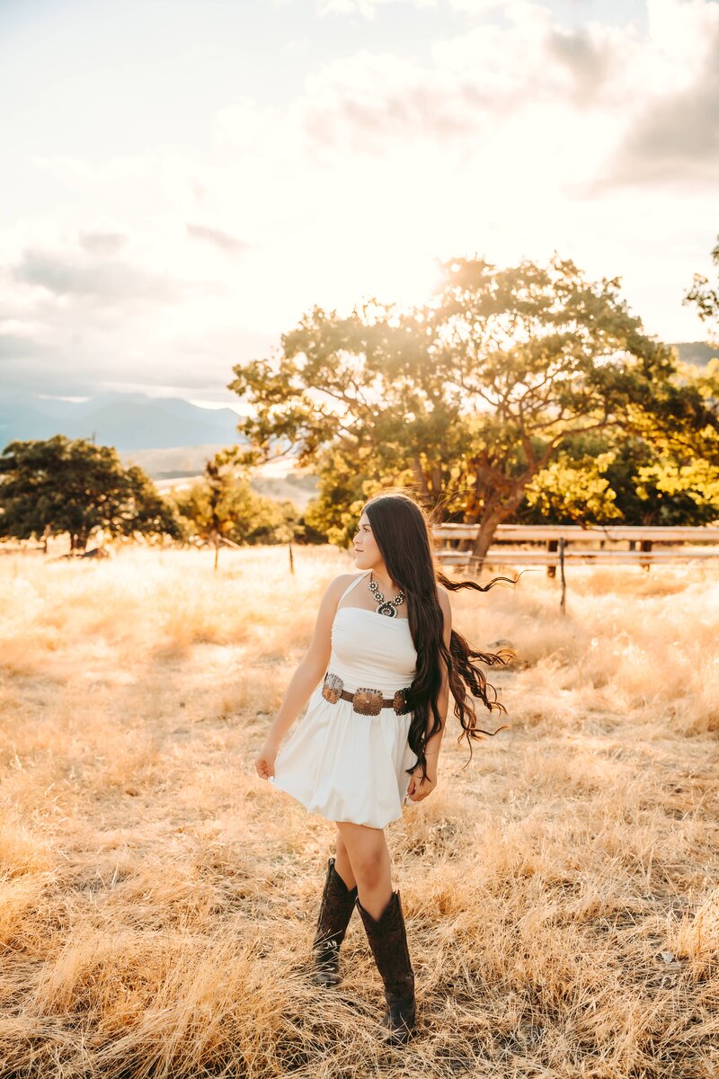 Senior with Boots in a Field | Photography by Jocelyn