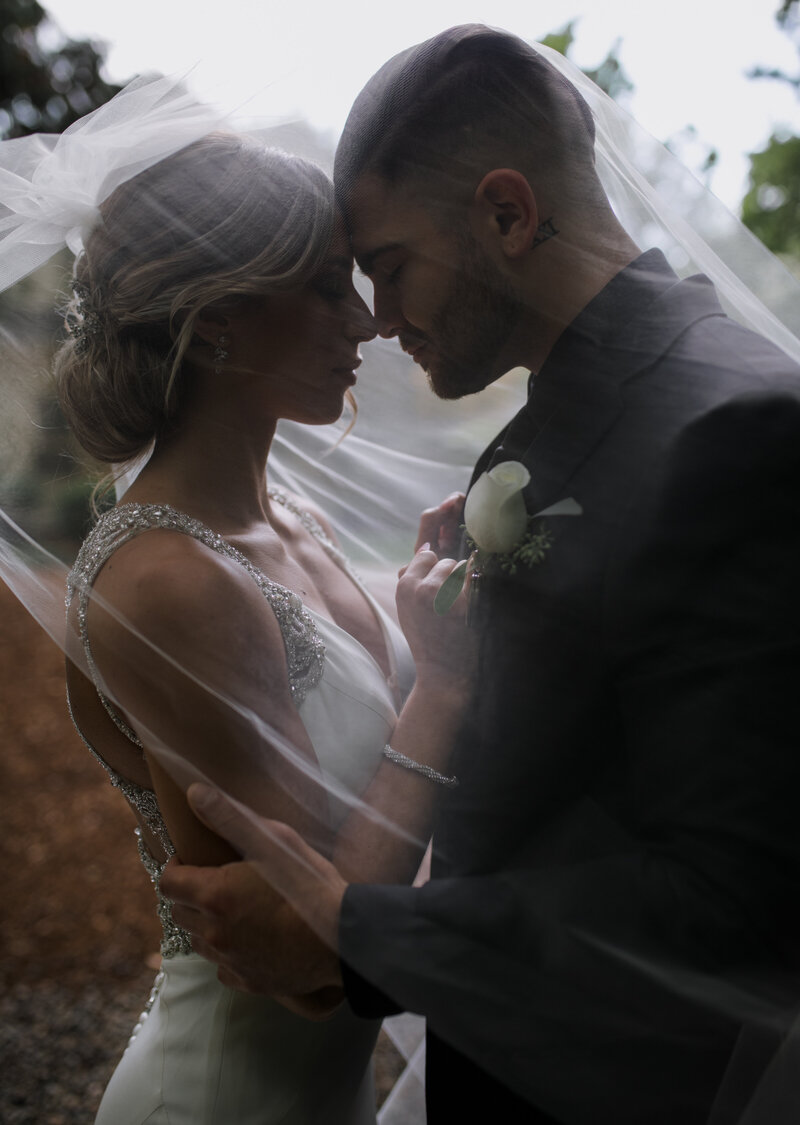 man and woman under wedding veil