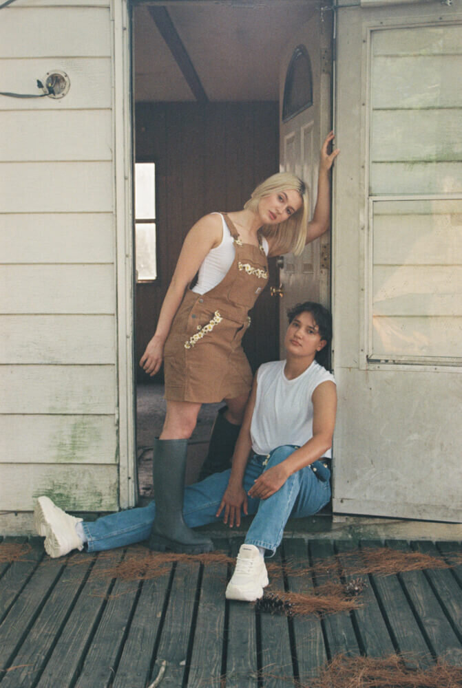 A couple in a doorway of an old house, representing an example of a styled photoshoot by Among the Oaks. 