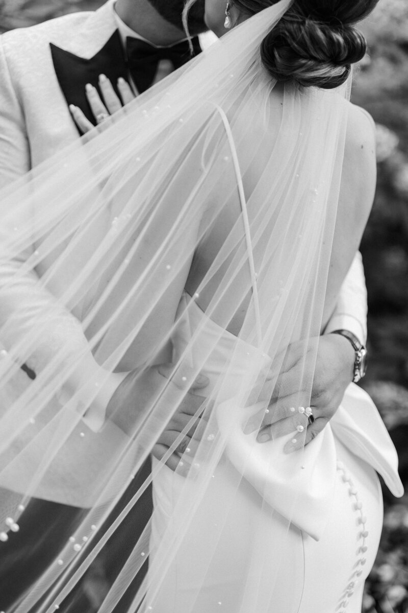 bride and groom embraced black and white image