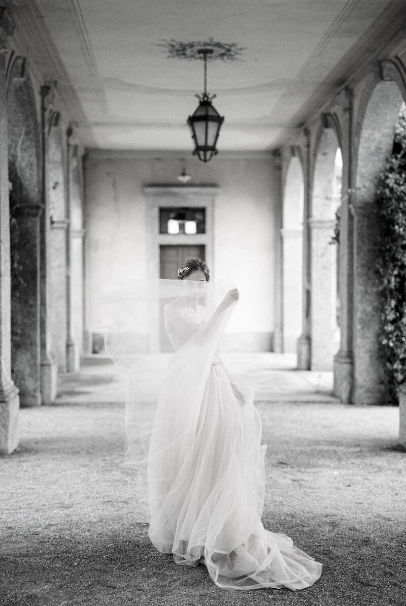 portugal bride-stands-on-the-terrace-covering-her-face