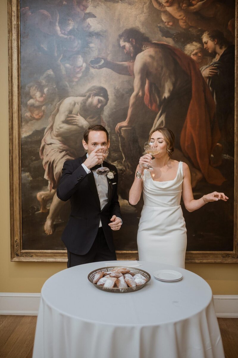 Drinking-Champaign-and-eating-beignets-in-New-Orleans-Museum-of-Art-Wedding-NOMA-.jpg