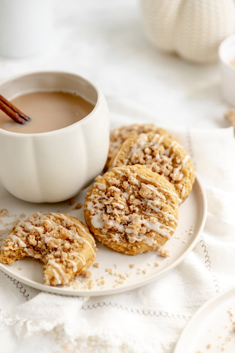 cookies on a plate with a mug filled with coffee