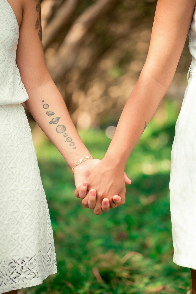 Lesbian couple holding hands after their first appointment at Blue Sky Fertility