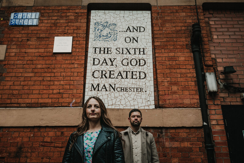 Alternative wedding photography of a couple next to a mural in Manchester