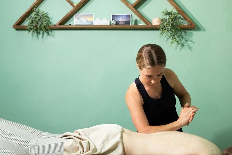 Devon Denys delivering a therapeutic massage in a peaceful, nature-inspired setting, enhancing the wellness experience.