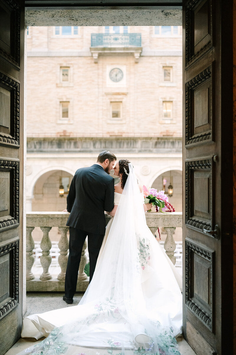 New England couple smiling at each other at their wedding