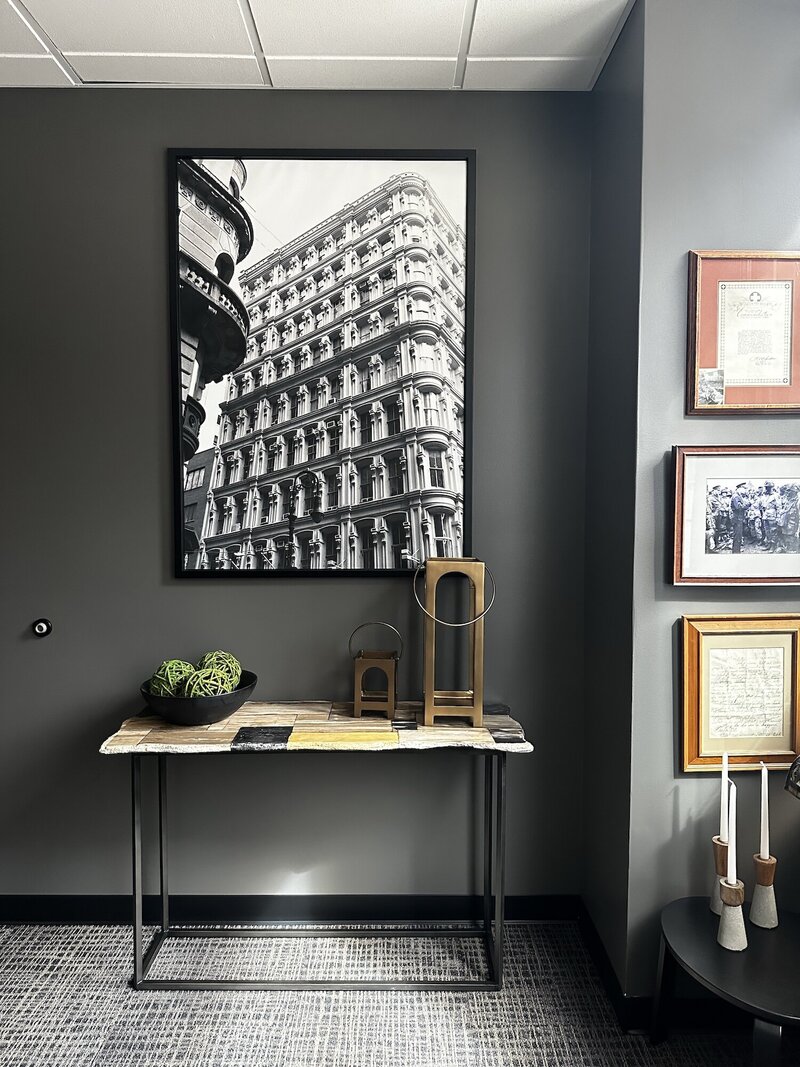 Large photo of a building framed next to a desk.